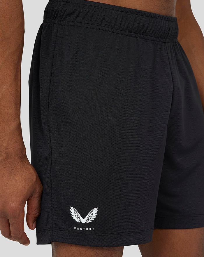 Close up of black 6 inch knitted shorts showing an elastic waistband and Castore logo at the hem.