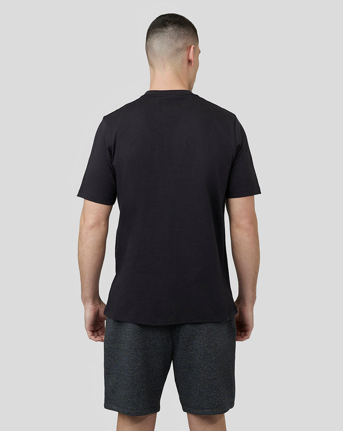 Back view of a man wearing a black short sleeve T shirt with a crew neck.
