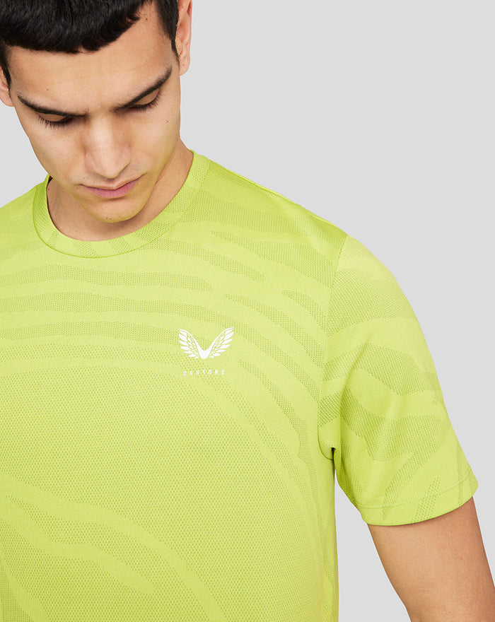 Close-up of neon lime Core Tech T-Shirt fabric showing texture and chest logo.
