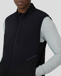 Front view of a model wearing the Black Cobalt Capsule Hybrid Gilet over a grey long sleeve with a stand collar and zip pockets