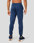 Back view of navy Peacoat Scuba Jogger with vertical Castore branding along the lower leg and navy sneakers