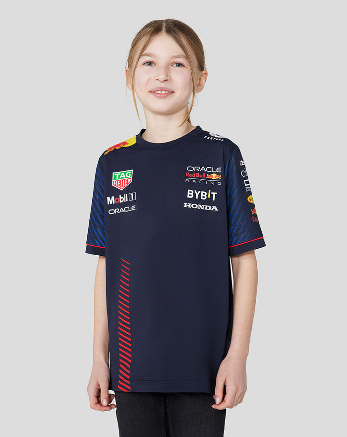 Front view of a smiling girl in a navy Set Up T Shirt with sponsor logos on the chest