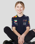 Front view of a young girl in the navy Set Up T Shirt with sponsor logos on the chest