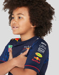 Side view of young child in navy Set Up T-Shirt with sponsor logos on chest and sleeve.